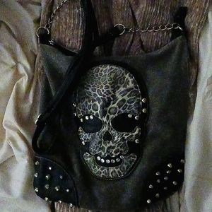 I'm selling this cute emo School purse and it is so cute but there's a tiny hole